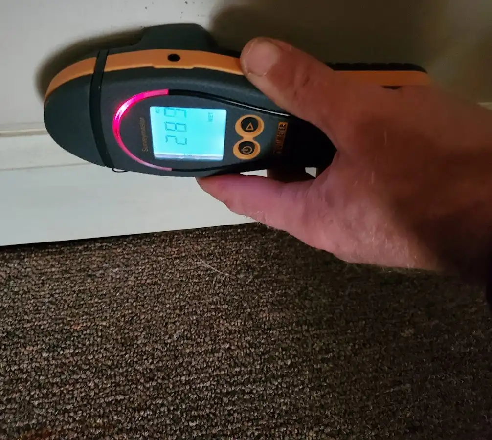 Moisture detection at baseboard during Storm Damage Restoration in Woodstock